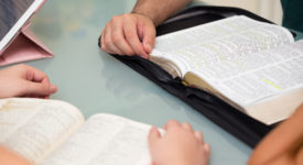 Close-up of People Reading the Word of God together